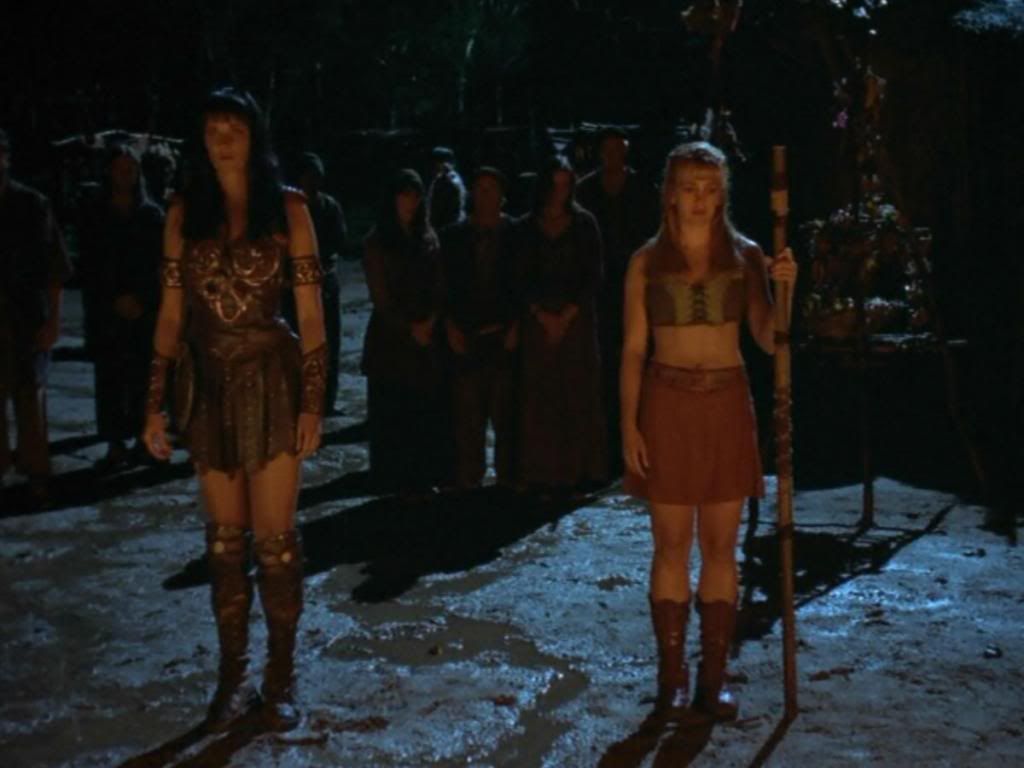 Xena and Gabrielle hold funeral pyres.